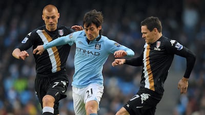 David Silva under pressure from Fulham's Steve Sidwell and German Sascha Riether in 2013. AFP