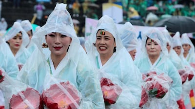 Women attending a lotus lantern parade, in celebration of the upcoming birthday of Buddha, wear raincoats in the rain before the start of the parade in Seoul, South Korea. Kwak Sung-Kyung / Reuters