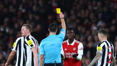 Arsenal's Eddie Nketiah is shown a yellow card by referee Andrew Madley. Reuters