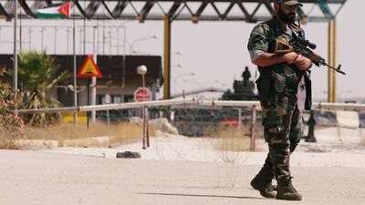 A Syrian soldier is seen standing in the Nasib border crossing with Jordan in Deraa, Syria July 7, 2018.REUTERS