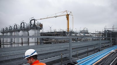 Absorber towers, left, and a construction crane stand on the gas cleaning installation at the Boekelermeer storage site, operated by Abu Dhabi National Energy Co (Taqa) and EBN BV, the Dutch state-owned energy company, in Alkmaar, Netherlands. Taqa started preliminary commercial operations at the site. Jasper Juinen / Bloomberg