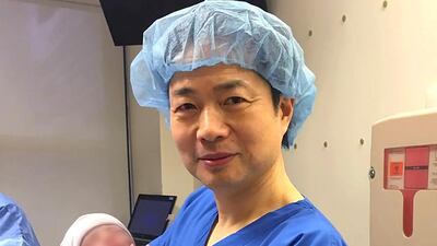 Dr John Zhang with the world’s first baby born using DNA from three people. Courtesy New Hope Fertility Centre
