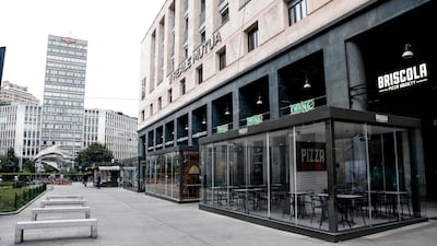 Diaz square is deserted and shops are closed in Milan. EPA