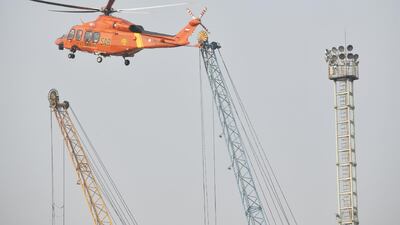 A search-and-rescue helicopter flies during an operation at the Jakarta port. AFP