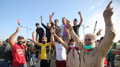Protestors stand by cement blocks blocking a bridge leading to the Green Zone. AFP