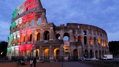 Rome's ancient Colosseum is lit with colours of the Italian flag to show unity, solidarity and to honour victims of the coronavirus. Reuters