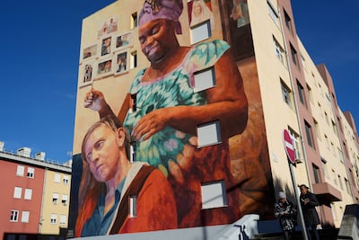 A mural inspired by the UN Sustainable Development Goal to end poverty in Amadora, Portugal. More than 800 million remain mired in extreme poverty. AP