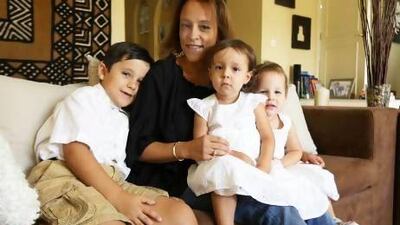 Gabriella Reynolds with her son Sam, left, and daughters Emma, centre, and Tess, right, at her villa in the Gardens in Dubai. Pawan Singh / The National