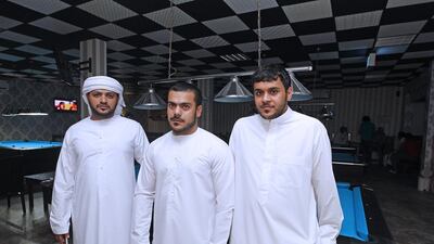 From left, Fahid Al Mansoori, 33, Yousef Alhosani, 22, and Abdulla Al Ali, 22, in Umm Al Quwain want better pensions and infrastructure from FNC members. Jeffrey E Biteng / The National