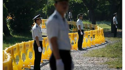 South Korean police officers stand guard in front of a barrier near a hotel, where the G20 meeting is being held in Busan, South Korea.
