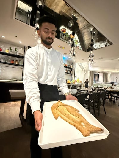 The herb-crusted sea bass is a show-stopping dish at Carine. Photo: Gemma White