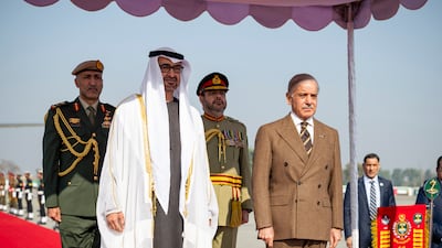 President Sheikh Mohamed and Shehbaz Sharif stand as the national anthems are played. Hamad Al Kaabi / UAE Presidential Court