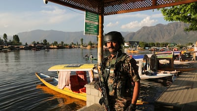 An Indian paramilitary soldier stands guard on the banks of Dal Lake. EPA