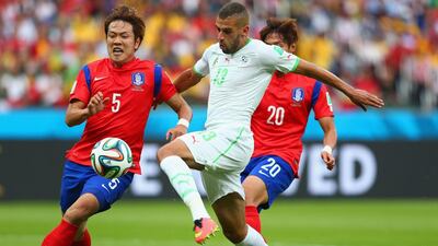 Islam Slimani of Algeria breaks away to score his team's first goal in a 4-2 win over South Korea on Sunday at the 2014 World Cup. Quinn Rooney / Getty Images