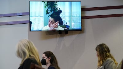 Pennington on screen above the spectators in the Virginia courtroom. EPA