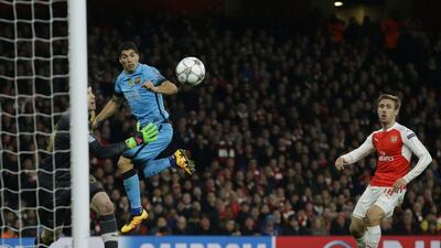 Barcelona's Luis Suarez heads the ball towards goal during the Champions League round of 16 first leg soccer match between Arsenal and Barcelona at the Emirates stadium London, Tuesday, Feb. 23, 2016. (AP Photo/Matt Dunham)