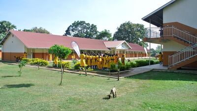 Pupils from St Katherine Secondary School gather around a teacher demonstrating a goat circumcision. Roberta Pennington / The National