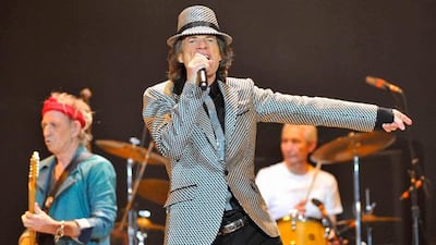 Mick Jagger (C), Keith Richards (L) and Charlie Watts (R) perform with the Rolling Stones at the O2 Arena in London November 25, 2012. The Stones took to the stage on Sunday after a five-year hiatus to celebrate the golden jubilee of one of the most successful and enduring bands in rock and roll history. Now in their mid-60s to early 70s, lead singer Jagger, guitarists Richards and Ronnie Wood and drummer Watts were joined by former members Bill Wyman and Mick Taylor for concerts in London and the United States. REUTERS/Toby Melville (BRITAIN - Tags: ENTERTAINMENT)