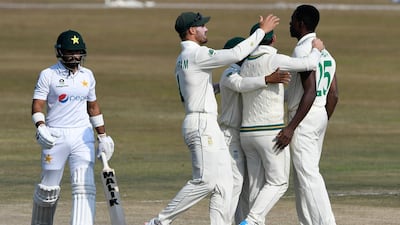 South Africa's Kagiso Rabada, right, celebrates with teammates after taking the wicket of Pakistan opener Imran Butt for a duck. AFP
