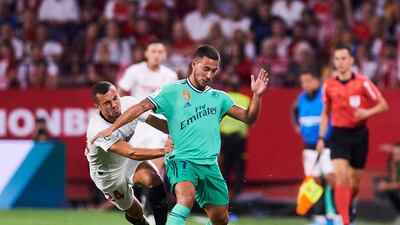 Eden Hazard holds off Sevilla's Joan Jordan. Getty Images