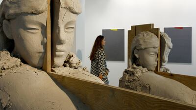 A visitor looks at the artwork of the Artist Mark Manders - Room with Unfired Clay Figures - exposed in the Statement Area during the press preview for Art Basel at Basel Messe on June 15, 2016 in Basel, Switzerland. Michele Tantussi / Getty Images