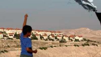 A Palestinian boy flies a homemade kite near the Jewish settlement of Maale Adumim in the occupied West Bank.