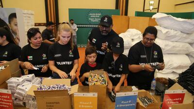 Volunteers pack the back to school kits for distribution to disadvantaged children in the UAE