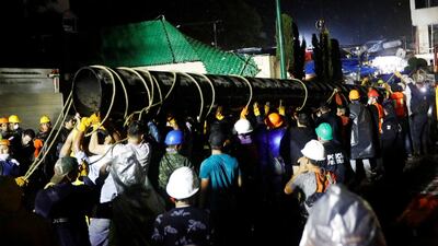 Workers carry a tube during the search for students at Enrique Rebsamen school after an earthquake in Mexico City. Edgard Garrido / Reuters