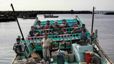 In this Sept. 29, 2018, photo, fishermen take a break and chew Qat, an amphetamine-like stimulant, on a boat at the main fishing port, in Hodeida, Yemen. (AP Photo/Hani Mohammed)