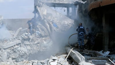 Fireman extinguish smoke that rises from the damage of the Syrian Scientific Research Center which was attacked by U.S., British and French military strikes to punish President Bashar Assad for suspected chemical attack against civilians, in Barzeh, near Damascus, Syria, Saturday, April 14, 2018. The Pentagon says none of the missiles filed by the U.S. and its allies was deflected by Syrian air defenses, rebutting claims by the Russian and Syrian governments. Lt. Gen. Kenneth McKenzie, the director of the Joint Staff at the Pentagon, also says there also is no indication that Russian air defense systems were employed early Saturday in Syria. AP Photo/Hassan Ammar