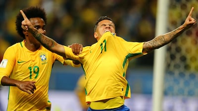 Philippe Coutinho, No 11, of Brazil celebrates his goal against Ecuador with teammate Willian. Pilar Olivares / Reuters