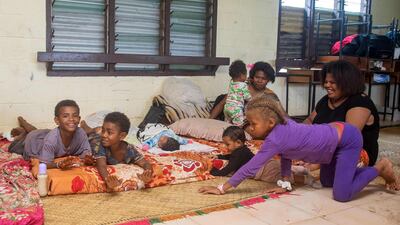A Fijian family takes refuge in a temporary shelter in the capital city of Suva. AFP