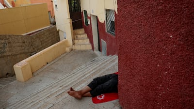 A migrant sleeps on outdoor steps after mass crossings from Morocco into the Spanish enclave of Ceuta. Reuters