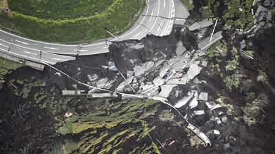 In this aerial photo, the landslide caused by the earthquake disrupts the road in Minamiaso town, Kumamoto prefecture, southern Japan. A powerful earthquake struck southern Japan early Saturday, barely 24 hours after a smaller quake hit the same region. Kyodo News via AP