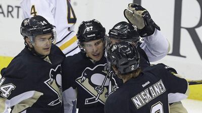Sidney Crosby (center) has led the defending Atlantic Division champion Penguins to a 2-0 start. Gene J. Puskar / AP