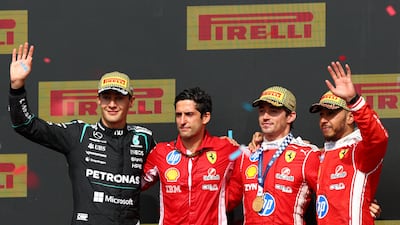 Left to right: Second-placed Mercedes driver, George Russell, Ferrari engineer Bryan Bozzi, race winner Charles Leclerc alongside his Ferrari teammate Lewis Hamilton who was third. Getty Images