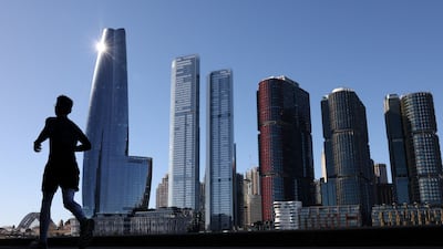 A man jogs past the Barangaroo skyline in Sydney, Australia. Reuters