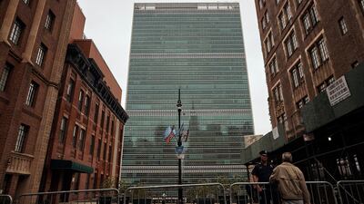 A man talks to a police office outside the UN building in New York. AP