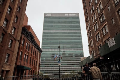 A man talks to a police office outside the UN building in New York. AP