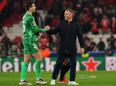 Barcelona coach Hansi Flick, right, congratulates Wojciech Szczesny after his fine performance against Benfica in the first leg. Getty Images