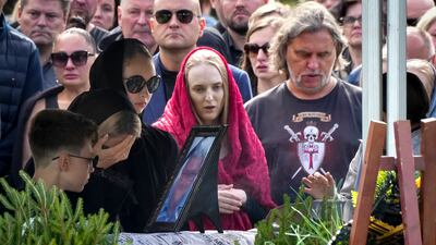 People mourn by the coffin of Chekalov, who was killed in the same plane crash as Prigozhin, at the Severnoye cemetery. AP