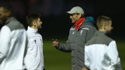 Liverpool manager Jurgen Klopp talks with Adam Lallana at a training session last week. Alex Livesey / Getty Images / November 25, 2015