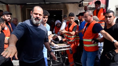 Members of Health and Medical Workers in Sidon transfer a wounded Palestinian injured during clashes at the Ain Al Hilweh camp in July. EPA