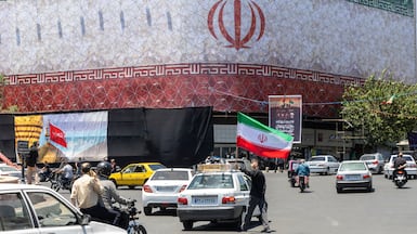 A billboard with the Iranian flag in Tehran, Iran. The US and Iran have agreed to end the war and open the Strait of Hormuz. Getty Images