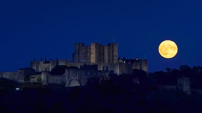 The harvest moon glows over Dover Castle in Kent, UK. PA