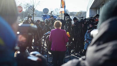 German chancellor Angela Merkel, leader of the conservative Christian Democratic Union (CDU), gives a statement as she arrives for further talks to form a new government in Berlin. Gregor Fischer / AFP