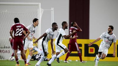 Al Sadd players celebrate scoring against Al Wahda. Christopher Pike / The National