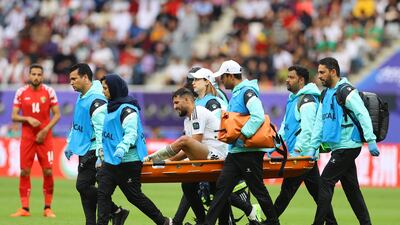 Iraq's Saad Natiq Naji is stretchered off after sustaining an injury. Reuters