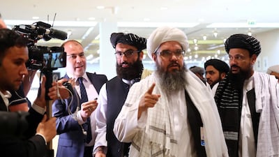 Members of Afghanistan's Taliban delegation speak to the media ahead of an agreement signing between them and US officials in Doha, Qatar. Reuters