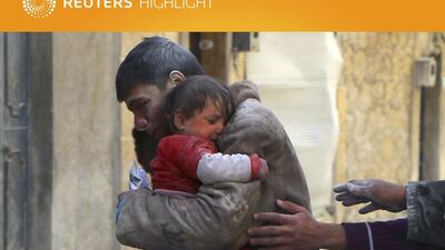 A boy holds his baby sister saved from under rubble, who survived what activists say was an airstrike by forces loyal to Syrian President Bashar Al Assad in Masaken Hanano in Aleppo on February 14, 2014. Hosam Katan/Reuters